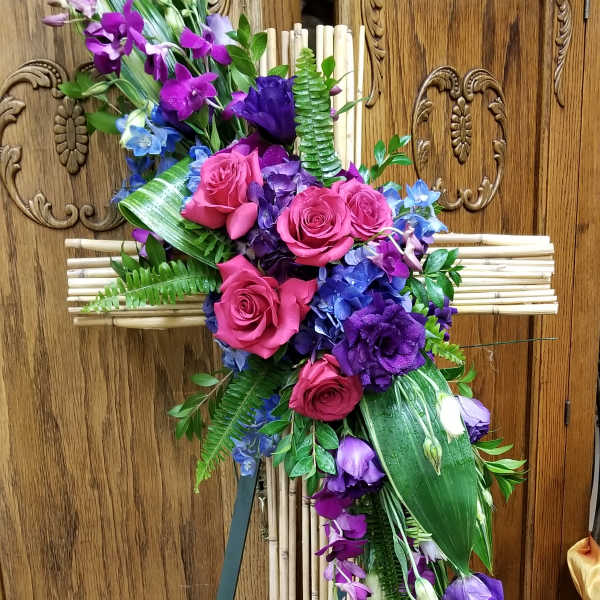 Purple and pink floral spray on a bamboo cross easel