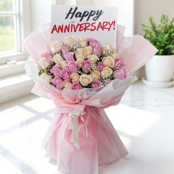 Pink and cream rose bouquet with an anniversary card