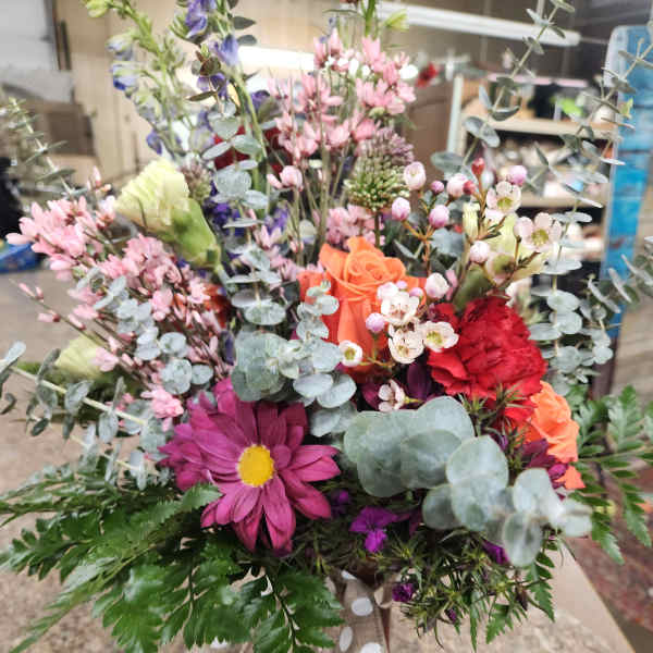 Mixed bouquet in a vase with pink, orange, red, and purple flowers