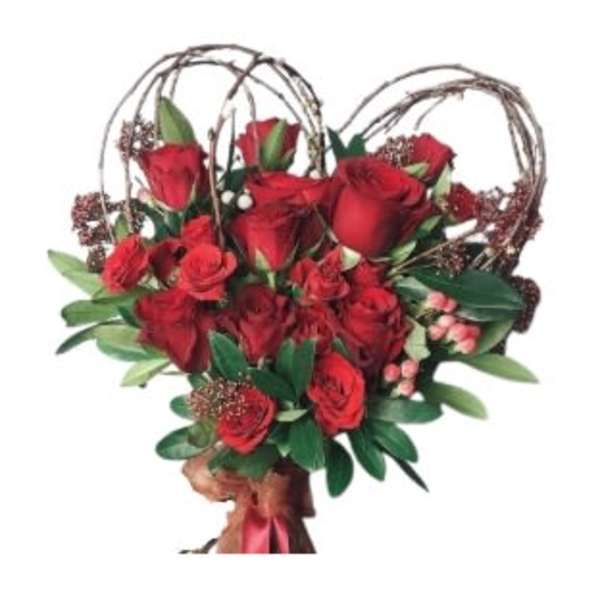 Heart-shaped bouquet of red roses framed with twig loops and tied with a red ribbon