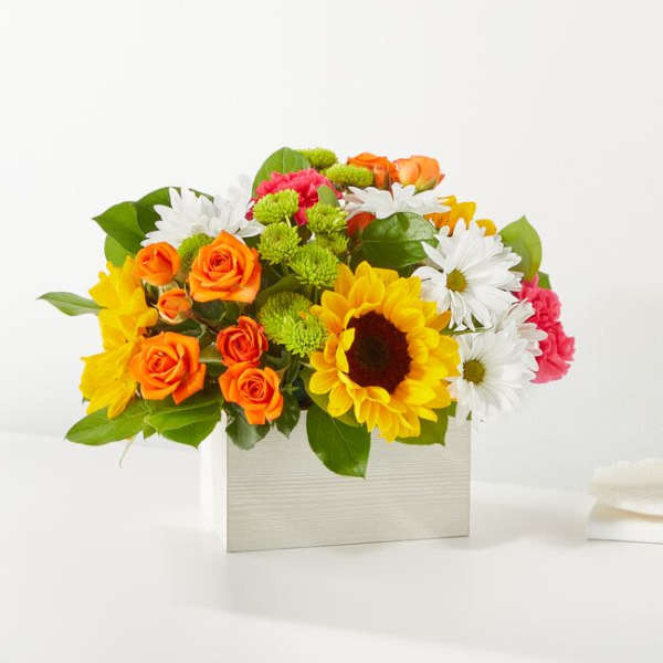 Bright mixed bouquet in a white rectangular box with sunflowers, roses, and daisies