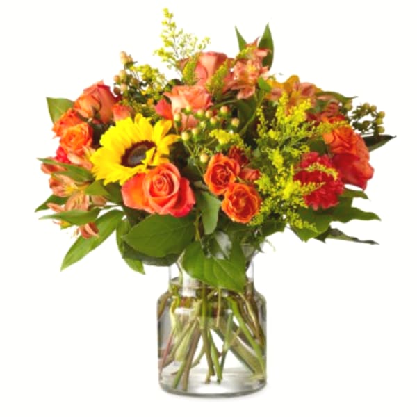 Bouquet of orange roses and a yellow sunflower in a glass vase