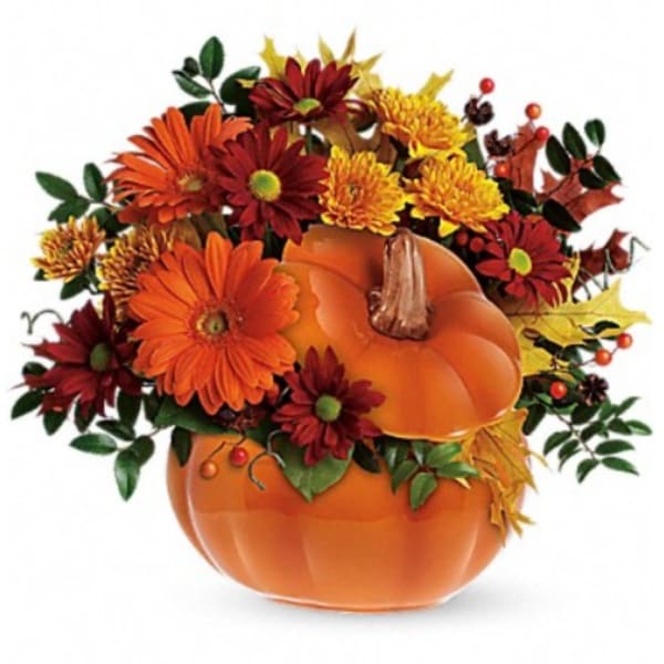 Orange pumpkin arrangement with red and yellow flowers
