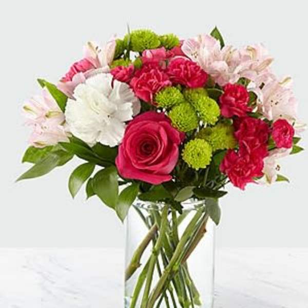 Bouquet of pink and white flowers in a clear glass vase