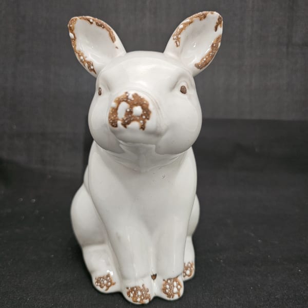 White ceramic pig figurine with brown speckled accents