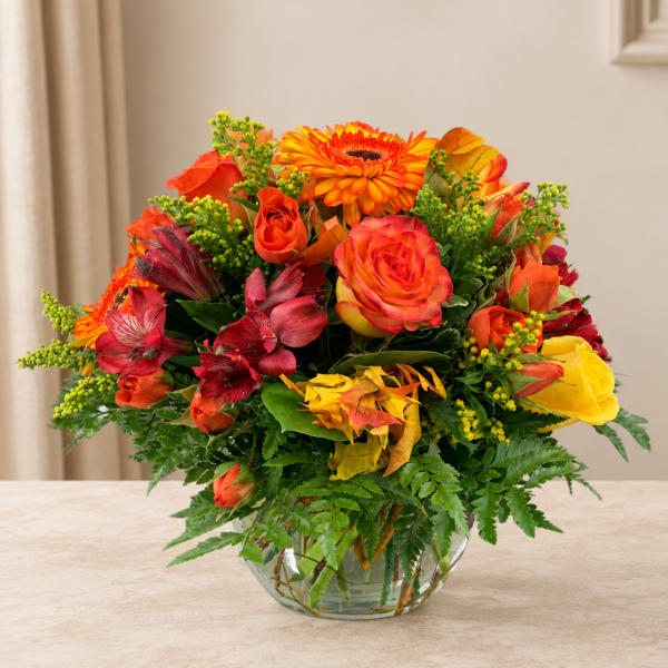 Bright mixed bouquet in a clear glass bowl vase