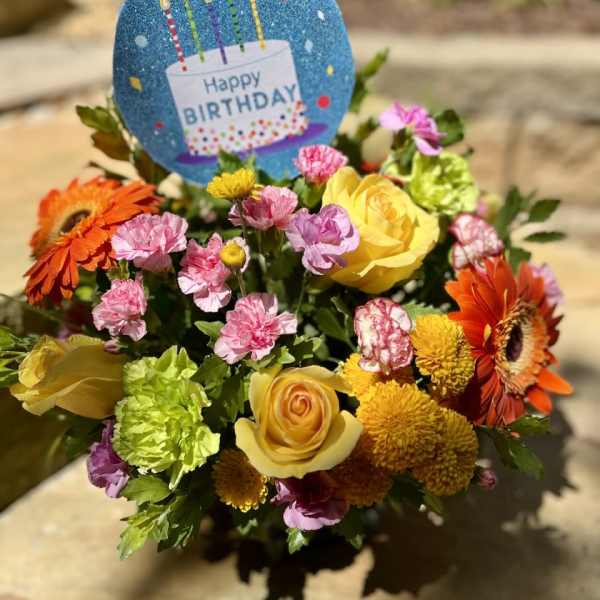 Birthday bouquet with yellow roses, orange gerberas, and pink carnations