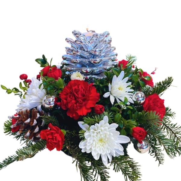 Christmas floral arrangement with red and white flowers and a silver pinecone topper