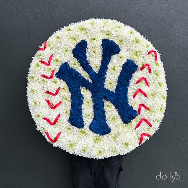 Round floral tribute with a blue Yankees logo and red stitching accents
