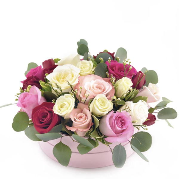Mixed roses in a pink round box with eucalyptus