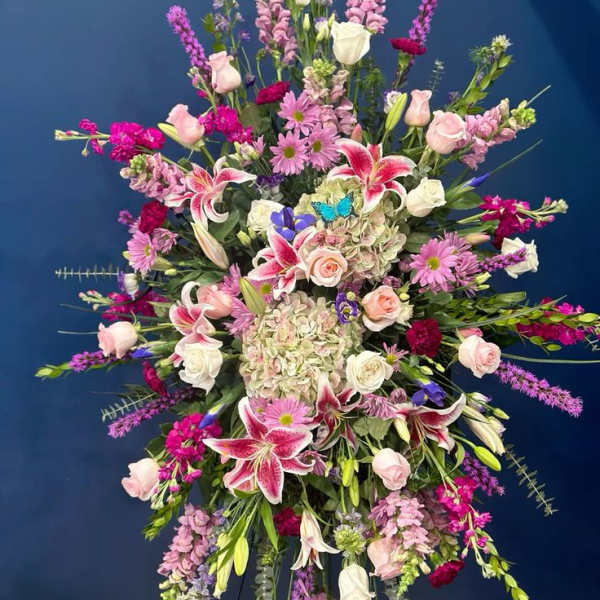 Large standing spray of pink, white, and purple flowers