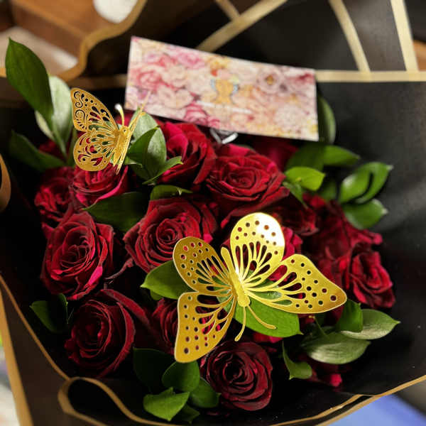 Bouquet of deep red roses with gold butterfly picks