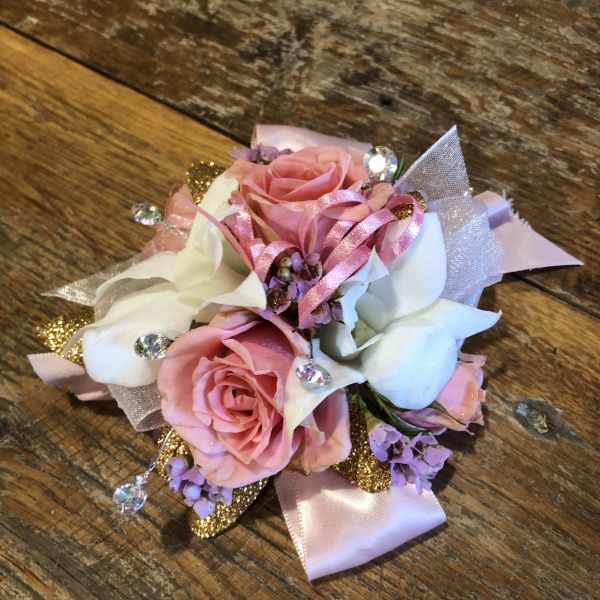 Pink and white rose corsage with ribbon and rhinestone accents