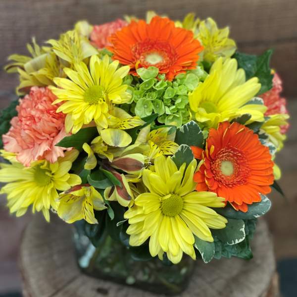 Bouquet of yellow and orange daisies with pink carnations