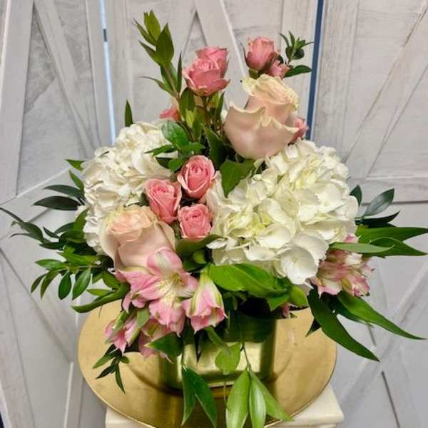 Pink roses and white hydrangeas arranged in a vase