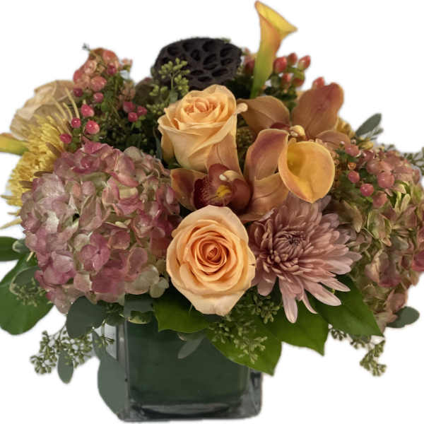 Peach roses and pink hydrangeas in a glass vase