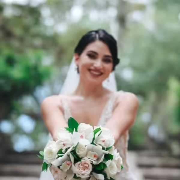 Bride holding a white and blush wedding bouquet