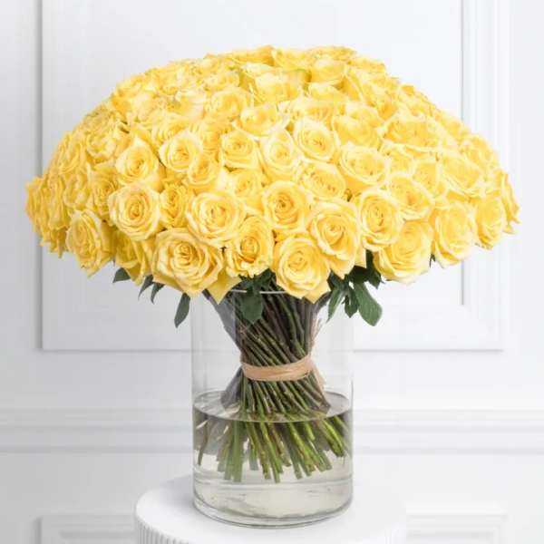 Large bouquet of yellow roses in a clear glass vase