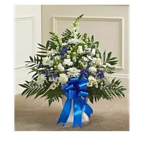 White and blue floral standing spray with a blue ribbon