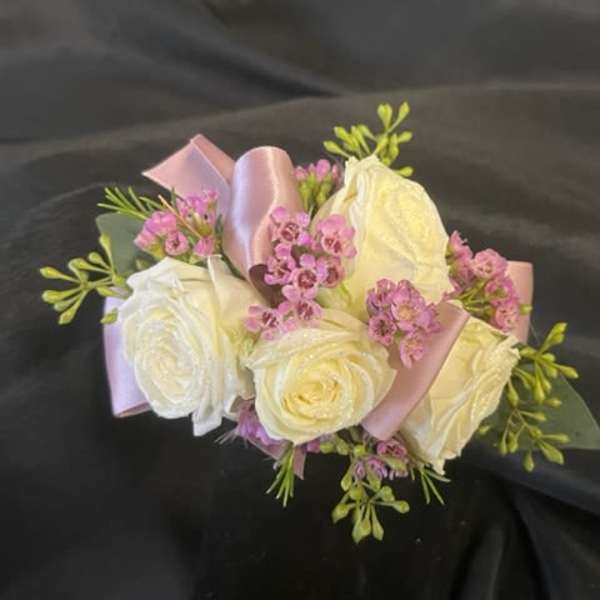 Bouquet of white roses with pink filler flowers and satin ribbon