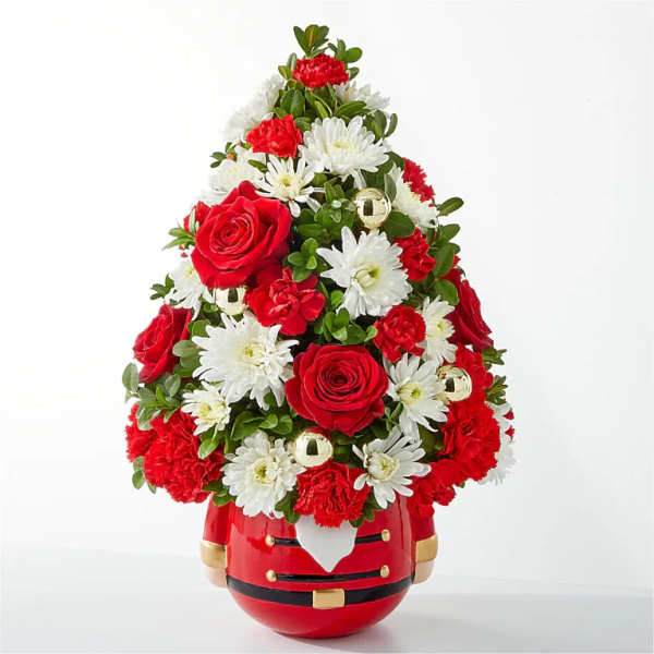 Red and white floral arrangement in a Santa-shaped container