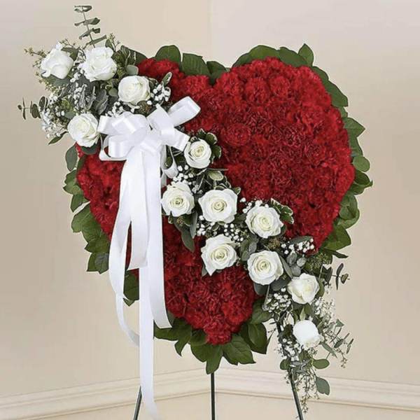 Heart-shaped red floral standing spray with white roses and ribbon