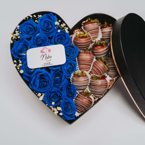Heart-shaped box with blue roses and chocolate-covered strawberries