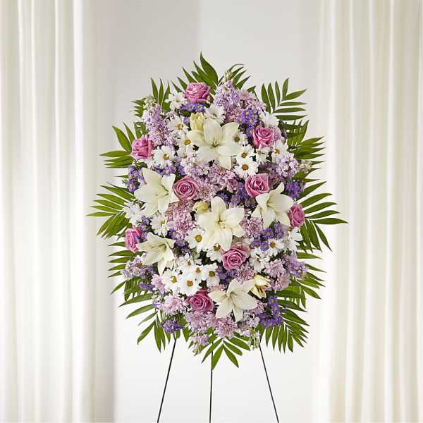Standing floral spray with pink roses, white lilies, and purple flowers