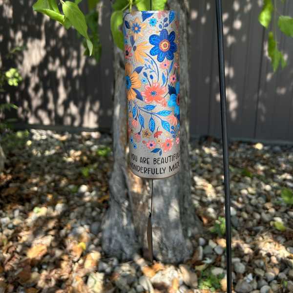 Floral-patterned hanging wind chime with a message