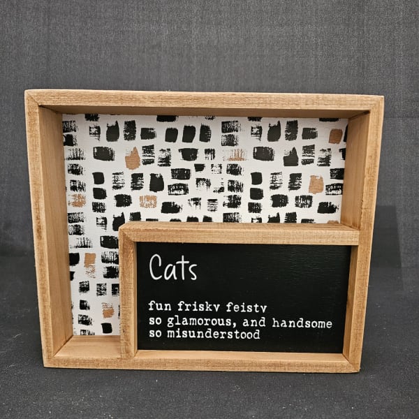 Wooden framed cat-themed sign with black-and-white patterned backing