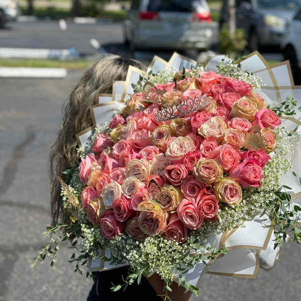 Large bouquet of pink and peach roses with white filler flowers