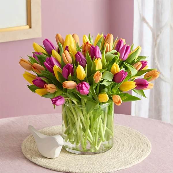 Bouquet of multicolored tulips in a clear glass vase