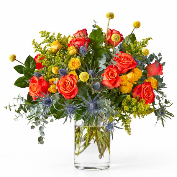 Bouquet of red and yellow roses in a clear glass vase