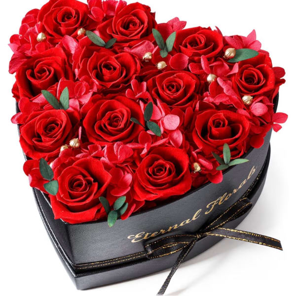 Heart-shaped box filled with red roses and pink accents