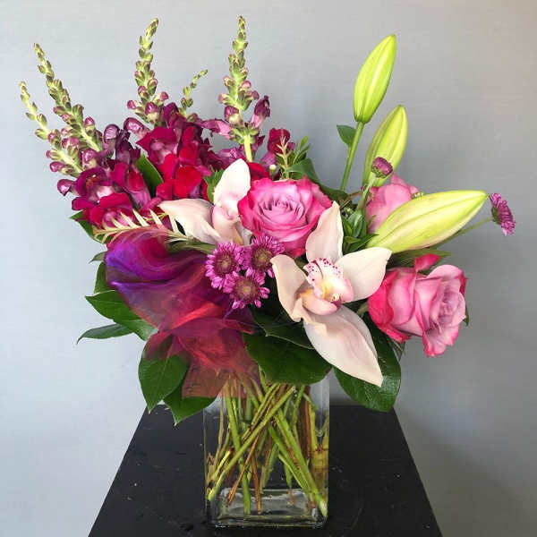 Pink and white floral arrangement in a clear glass vase
