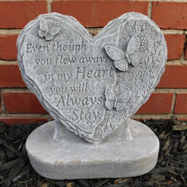 Heart-shaped memorial stone with butterflies and an engraved sympathy message