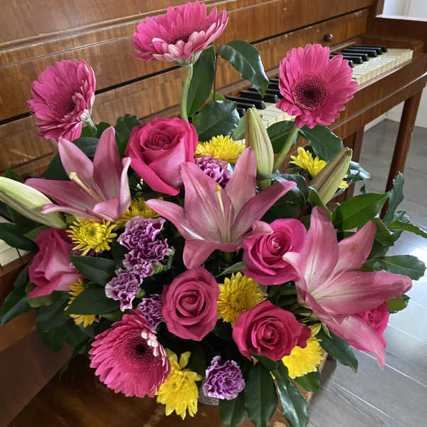 Bouquet of pink lilies, roses, gerbera daisies, and yellow mums