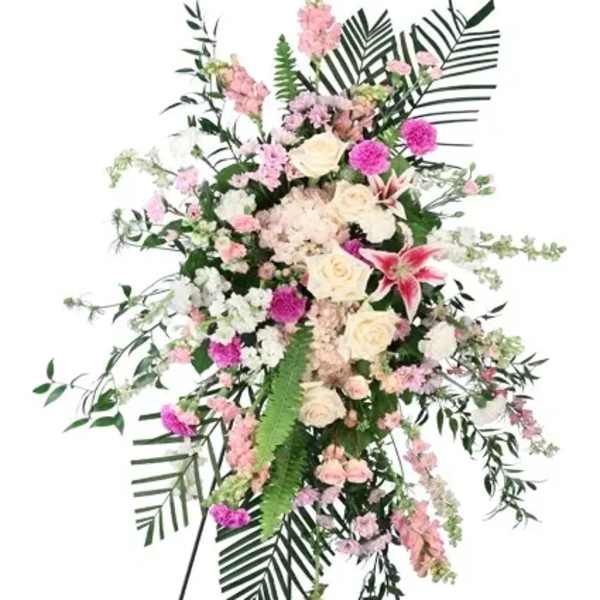 Standing floral spray with pink and white flowers on an easel