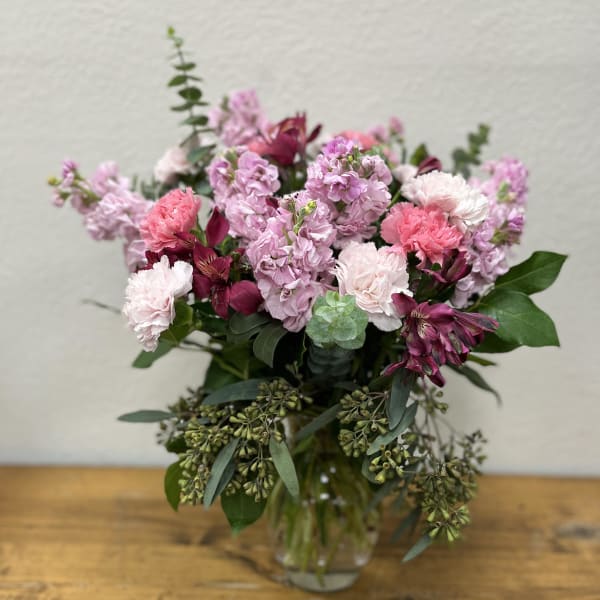 Pink and lavender bouquet in a clear glass vase