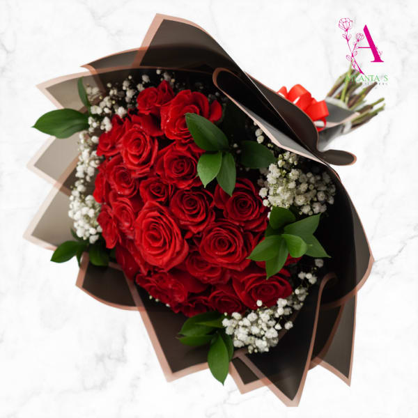 Bouquet of red roses with white baby's breath in dark wrap