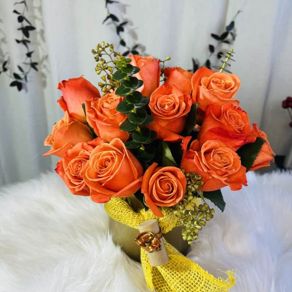 Orange rose bouquet wrapped with yellow mesh ribbon