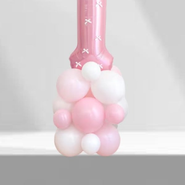 Pink number 1 balloon with a cluster of pastel balloons at the base