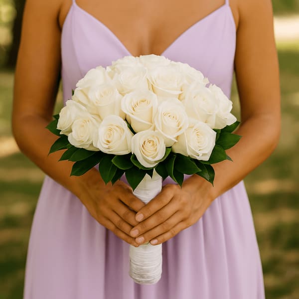 Bridal bouquet of white roses with dark green leaves