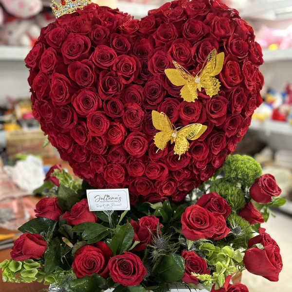Heart-shaped red rose arrangement with yellow butterfly accents