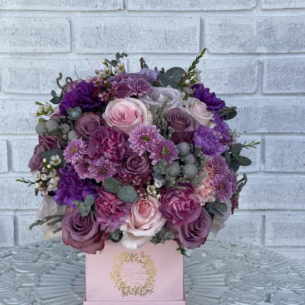 Pink and purple bouquet in a pink box