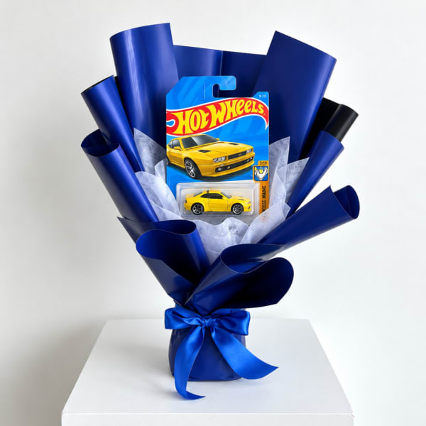 Hot Wheels toy car gift bouquet wrapped in blue paper with a ribbon