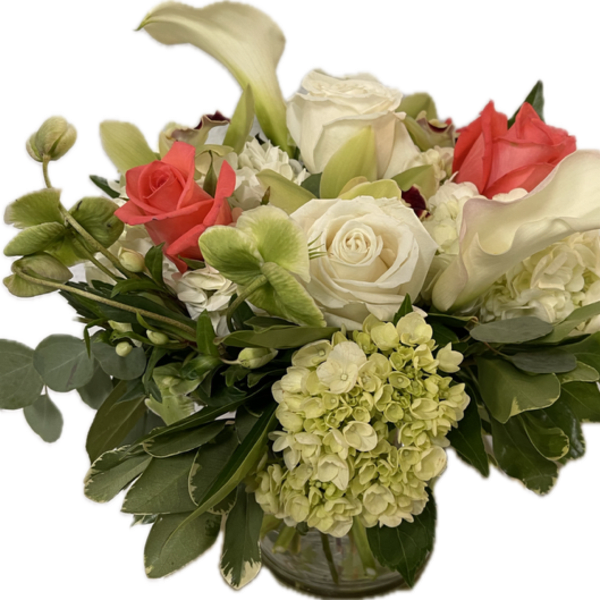 Low glass vase arrangement with white roses, white calla lilies, green hydrangeas, and coral roses.