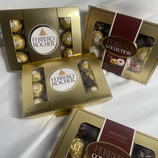 Boxes of Ferrero Rocher chocolates on white fabric