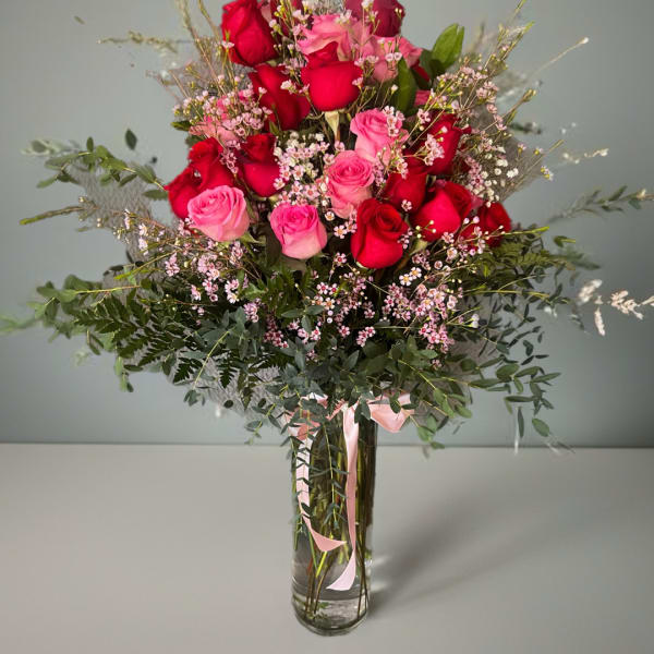 Bouquet of red and pink roses in a clear glass vase