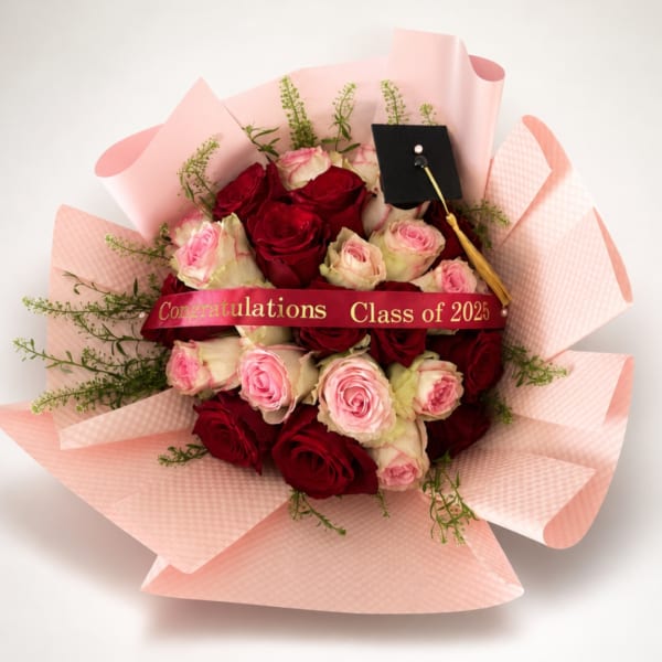 Bouquet of red and pink roses with a graduation cap ribbon